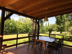 a wooden table and chairs on a porch with a view at Chalet Slap Na Kupi in Severin na Kupi