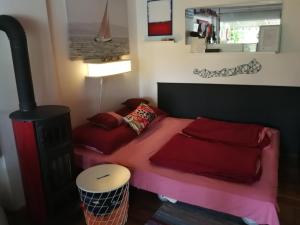 a room with a bed and a stove at Kis Vitorlás in Balatonmáriafürdő