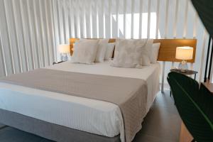 Posteľ alebo postele v izbe v ubytovaní APARTAMENTOS VIRGEN DEL CARMEN