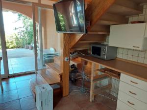 a kitchen with a counter with a microwave in it at Apartman Atanasov in Seline
