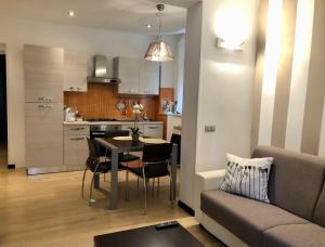 a living room and kitchen with a table and a couch at onde house casa vacanze Le Grazie in Portovenere