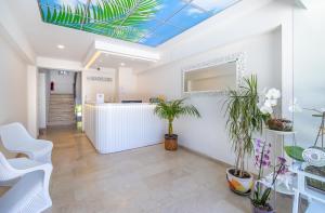 an office lobby with plants and a skylight at Princess Kinli Suites Hotel in Marmaris