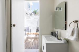 a bathroom with a sink and a mirror at Avila Beach in San Juan