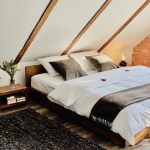 a bedroom with a large bed in a attic at La Brazi - by 663A Mountain Chalet in Porumbacu de Sus