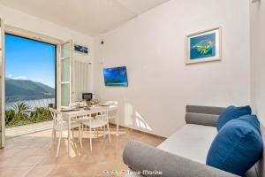a living room with a couch and a table at Pensieri Marini, TerreMarine in Corniglia +7 photos
