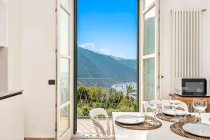 a dining room with a table and a view of the mountains at Pensieri Marini, TerreMarine in Corniglia