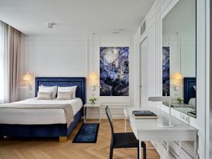 a hotel room with two beds and a painting on the wall at Hotel Indigo Warsaw Nowy Świat, an IHG Hotel in Warsaw