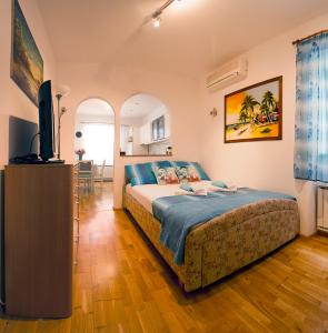 a bedroom with a bed and a flat screen tv at Apartment Taya in Piran