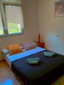a bedroom with a bed with two pillows on it at Canuta de Ifach 3H in La Canuta