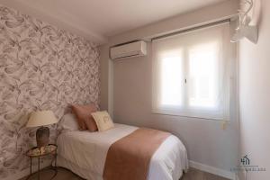 A bed or beds in a room at Living4Malaga Infinity Views Penthouse