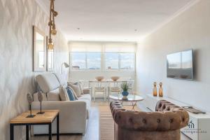 A television and/or entertainment centre at Living4Malaga Infinity Views Penthouse