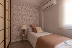 A bed or beds in a room at Living4Malaga Infinity Views Penthouse