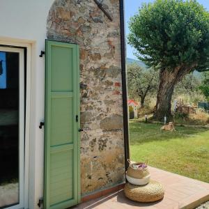 an open door to a building with a tree at La Casa Vecchia Bed&Breakfast in Caniparola di Fosdinovo