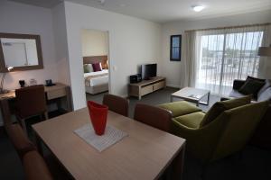 
a living room filled with furniture and a tv at Quest Palmerston - Darwin in Darwin
