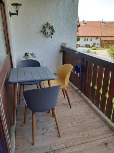 two tables and chairs sitting on a balcony at Schöne Aussichten in Missen-Wilhams