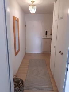 a hallway with a white door and a rug at Schöne Aussichten in Missen-Wilhams