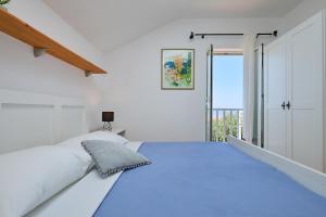 a white bedroom with a large bed and a window at Hedera Estate, Hedera Studio 2 in Dubrovnik