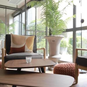 a living room with a couch and a coffee table at Hôtel Antares & Spa in Honfleur