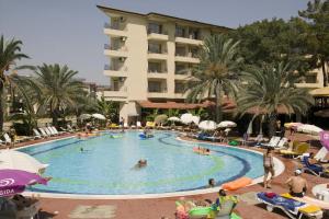 a large swimming pool with people in a hotel at Side Palm D'or Hotel in Side