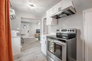 a kitchen with a stove and white cabinets at Charming Updated Condo in Heart of Tampa in Tampa +13 photos
