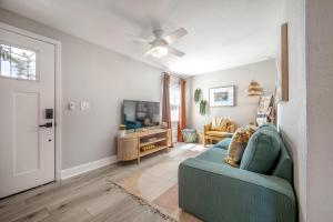 a living room with a blue couch and a tv at Charming Updated Condo in Heart of Tampa in Tampa