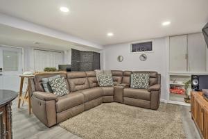 a living room with a brown couch and a table at Saddle Brook Studio with Patio - Near NYC! in Saddle Brook