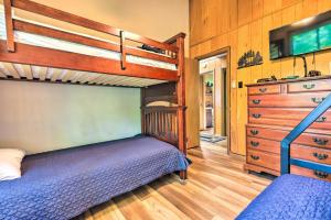 a bedroom with a bunk bed and a dresser at Spacious Albrightsville Home with Game Room! in Albrightsville