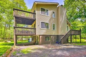 a large house with a deck on the side of it at Spacious Albrightsville Home with Game Room! in Albrightsville