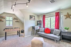 a living room with a couch and a ping pong table at Updated Retreat with Game Room and Boat Ramp Access! in Lago Vista