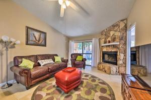 a living room with a couch and a fireplace at Jacksonville Home about 10 Mi to Downtown! in Jacksonville