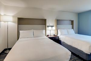 a hotel room with two beds and two lamps at Holiday Inn Mobile Airport, an IHG Hotel in Mobile