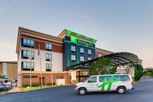 a green and white truck parked in front of a building at Holiday Inn Mobile Airport, an IHG Hotel in Mobile