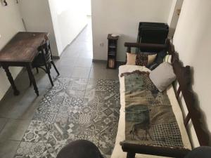 a room with a piano and a bed and a table at Sunset House in Serifos Chora