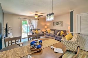 a living room with a couch and a table at Fairfield Bay Condo with Patio Less Than 5 Mi to Lake! in Fairfield Bay