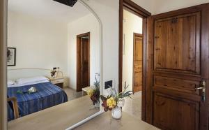 una camera da letto con un letto e un grande specchio di Relais Villa agave a Ischia Altre 14 foto