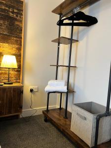 a towel rack in a room with a lamp at The Brookmill in London