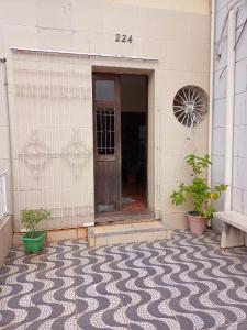 a front door of a building with a patterned floor at Pousada Pitanga in Maceió