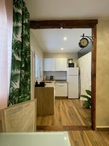 a kitchen with a white refrigerator and a counter top at Casa Alexandra in Las Lagunas