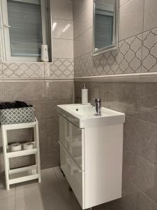 a bathroom with a white sink and a mirror at Szőlőskert vendégház in Balatonszőlős +49 photos