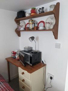 a kitchen with a microwave on a wooden table at Rosie's place in Hartland