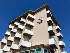 a building with a logo on the top of it at Little Hotel in Riccione
