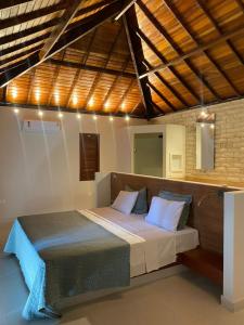 a bedroom with a large bed in a room at Vila Palmeiras in São Miguel do Gostoso