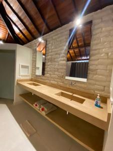 a bathroom with two sinks and a large mirror at Vila Palmeiras in São Miguel do Gostoso +18 photos