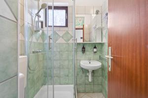 a small bathroom with a sink and a shower at Irene Bed & Breakfast Tisno in Tisno +54 photos