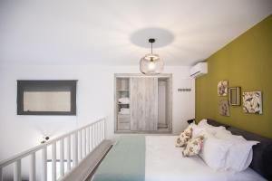 a bedroom with green and white walls and a bed at Amarynthos Maisonettes in Amarinthos