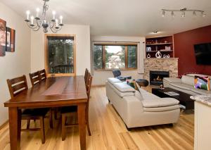 a living room with a dining room table and a couch at Greenbrier Townhouse 36 in Avon