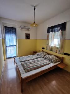 a bedroom with a large bed in a room at Anno 2000 in Balatonlelle