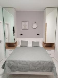 a bedroom with a large bed and a large mirror at Room and terrace in Krk