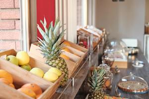 a group of wooden baskets of fruit on a table at Hotel Astoria in Bordighera +25 photos