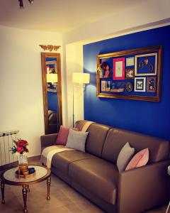 a living room with a couch and a table at Apartamentos La Estación M&S in Albacete